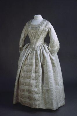 Silk dress, 1851, French; Ivory, trimmed with lace & silk fringes