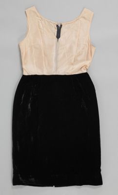 Matching black velvet dress and jacket with gold basket brooch