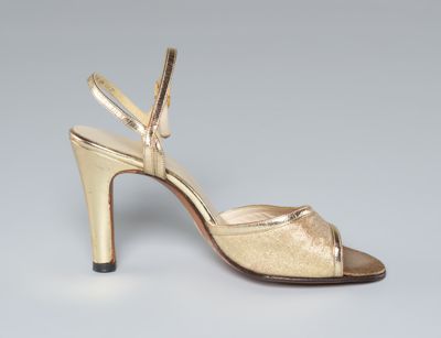Left gold heeled sandal with ankle strap