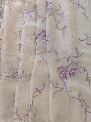Sari of white chiffon with a delicate pattern hand-embroidered in shades of purple and mauve. Probably embroidered in Karachi, Pakistan, 1962-80s