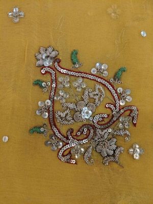 Yellow chiffon sari with hand-embroidered pattern in red, green and metallic thread and sequins. Embroidered in India or Pakistan, 1960s-1980s