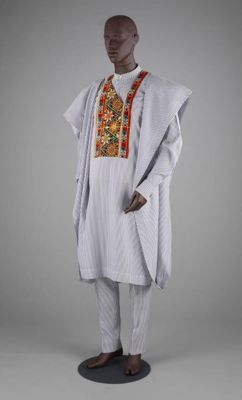 Agbádá ensemble of a robe, shirt, trousers and fìlà of striped cotton and cotton velvet with embroidery, ATAFO by Mai Atafo, Lagos, Nigeria, 2022